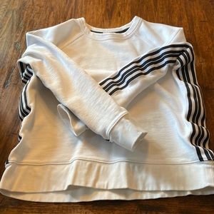 Athleta white sweatshirt with black and white strips down sides. Size M